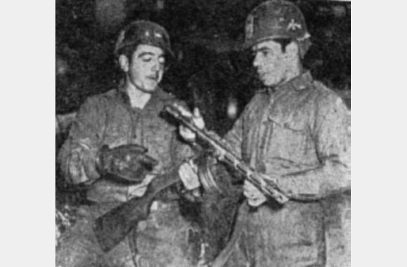 WANNA BURP?-SFC Virgilio Agosto-Baquero (left, Canovanas, P.R., and M/Sgt. Austin Montero-Negron, Utuado, P.R. examine a Chinese "burp gun" captured during a recent attack in Korea. The men are members of Company L of the 65th Puerto Rican Infantry Regiment. (U.S. Army Photo by Pvt. Peter Pineiro)