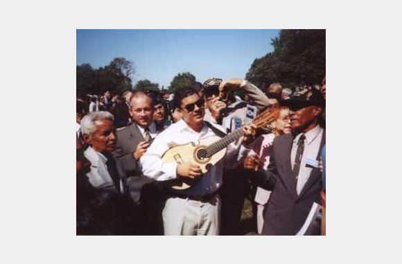 Mr. Alvin Medina,  New Jersey,  Plays the Quatro as the veterans sing Borinquena and the 65th Infantry Regimental Song