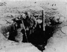  Nov 26, 1950 - Cpl. Eduardo Nevarez, gunner, and Sgt.  Jose R Acevedo, Loader, fire an 81 mm mortar in support of a Company of the 65th Inf. Regt. , 3rd Inf. Div. , during action against the Communist forces in Korea. Note the frost on tarpaulin, and use of ammo case for stove. U.S Army Photo by SFC Robert H. Forsythe