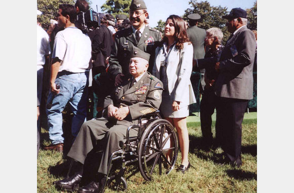 Two generations of Puerto Rican Combat Soldiers,  SSGT. Ramirez Sr.  (Wheelchair) 65th Infantry Regiment Veteran of the Korean War, his Son Colonel Ramirez (US Army), and Ms. Yadira Almodovar attend the dedication ceremony.