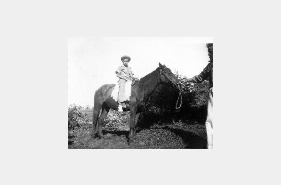 My uncle Juanin Nieves on horse back, being led by my grandfather Lorenzo Nieves Ortiz. - 1946