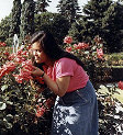 Millie smelling the flowers at the Botanicle Gardens in Queens. - 1980
