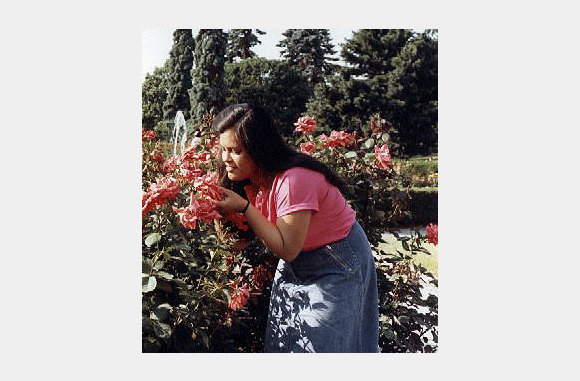 Millie smelling the flowers at the Botanicle Gardens in Queens. - 1980