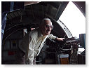 Clement Resto standing near waist gun of B17 "Sentimental Journey" at air show in Westchester County.